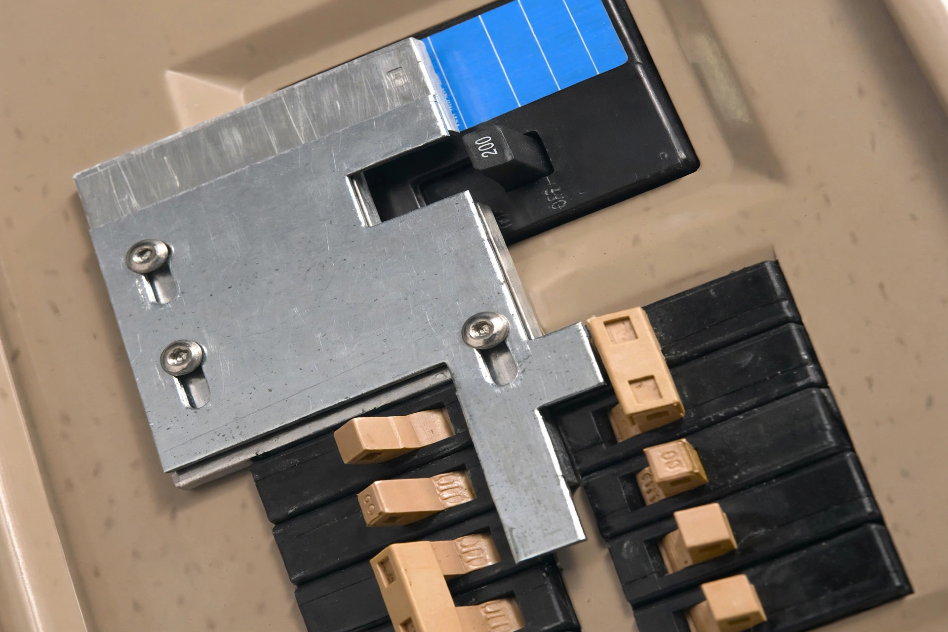 Close-up of sliding interlock plate mechanism on electrical panel cover, realistic, no text